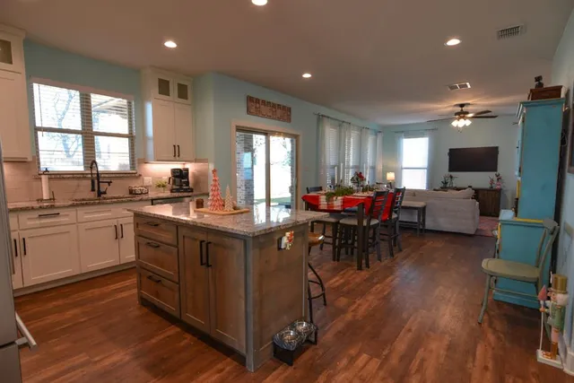 a kitchen with sink cabinets and wooden floor