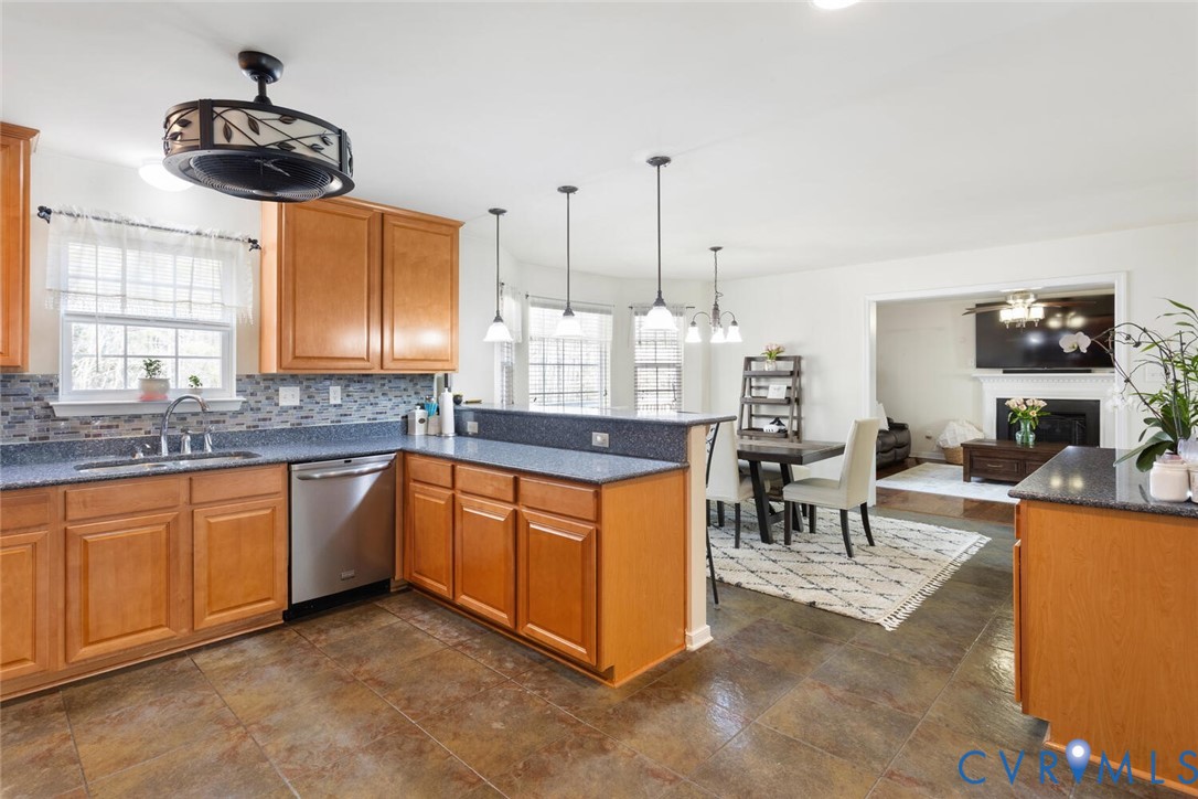 15650 River Road Chesterfield, VA 23838 - Photo 12 of 50 a kitchen with stainless steel appliances granite countertop a sink a stove and a wooden floors
