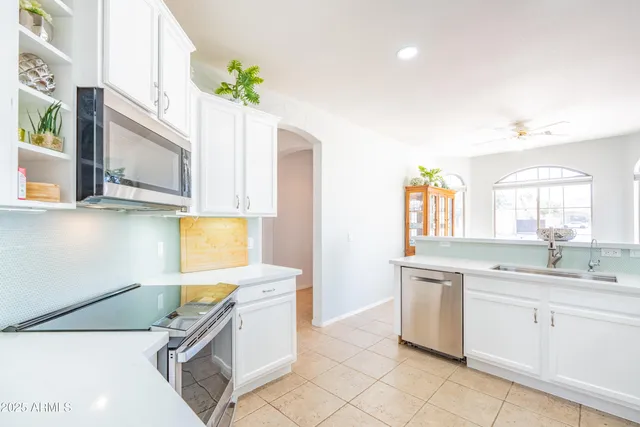 a view of a kitchen with appliances and furniture