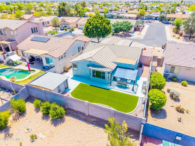an aerial view of a house with a swimming pool outdoor seating