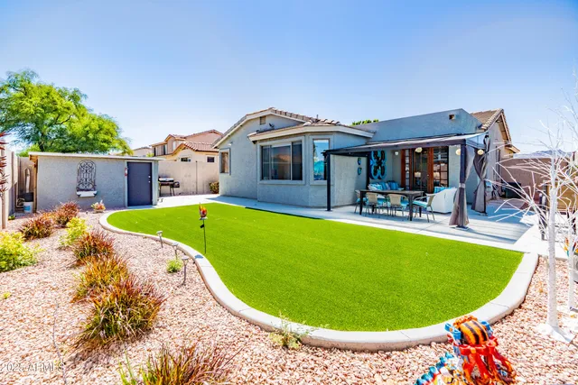 a view of a swimming pool with a chair and tables in the patio