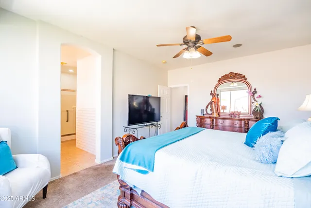 a bedroom with a bed and a chandelier