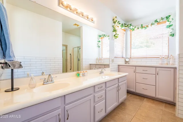 a bathroom with a sink double vanity and a mirror