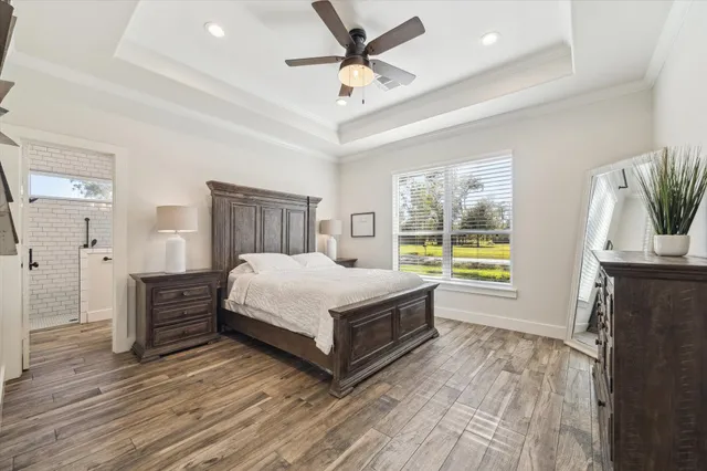 a front view of a house with a garden and trees