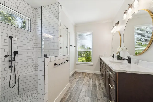 a kitchen with granite countertop white cabinets and a wooden floor