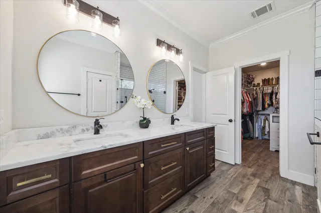 a bedroom with a bed and a flat tv screen on dresser
