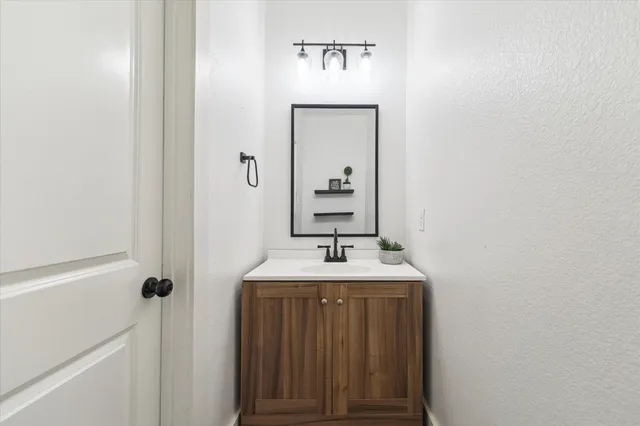 a bathroom with a double vanity sink mirror and toilet