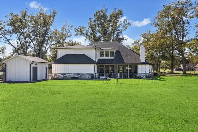a view of a porch with furniture and garden