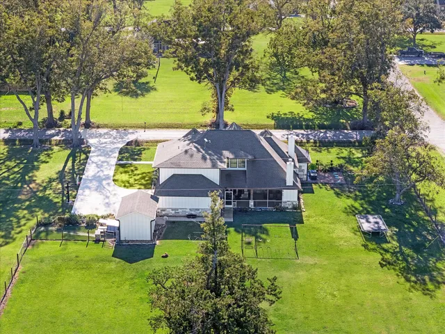 a view of a livingroom with furniture and a large window