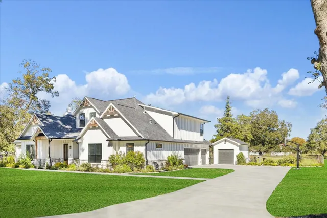 a front view of house with yard and green space
