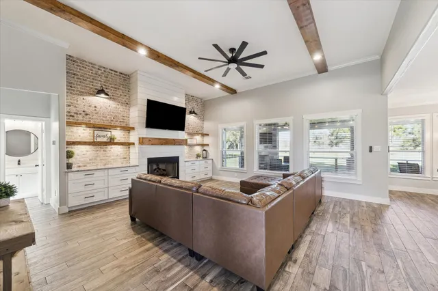 a living room with furniture a fireplace and a flat screen tv