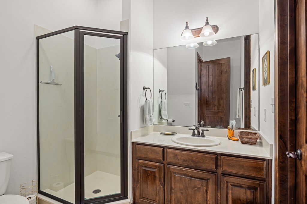 3801-12 Club House Road Kerrville, TX 78028 - Photo 13 of 23 a bathroom with a double vanity sink and a mirror