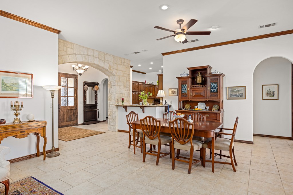 3801-12 Club House Road Kerrville, TX 78028 - Photo 6 of 23 a view of a dining room with furniture and a chandelier