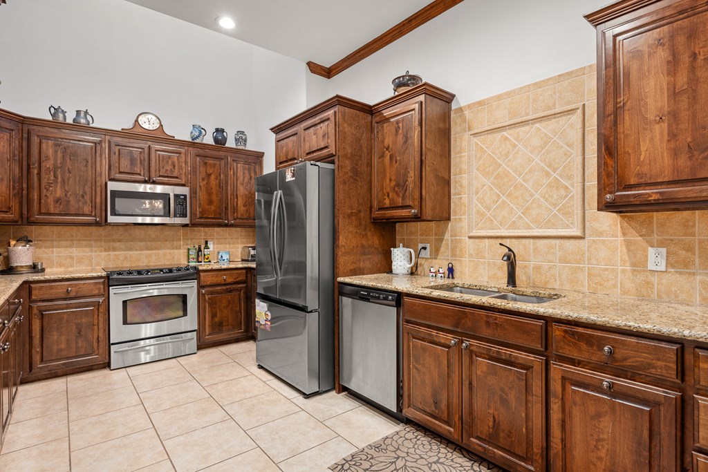3801-12 Club House Road Kerrville, TX 78028 - Photo 9 of 23 a kitchen with stainless steel appliances granite countertop a refrigerator sink and stove