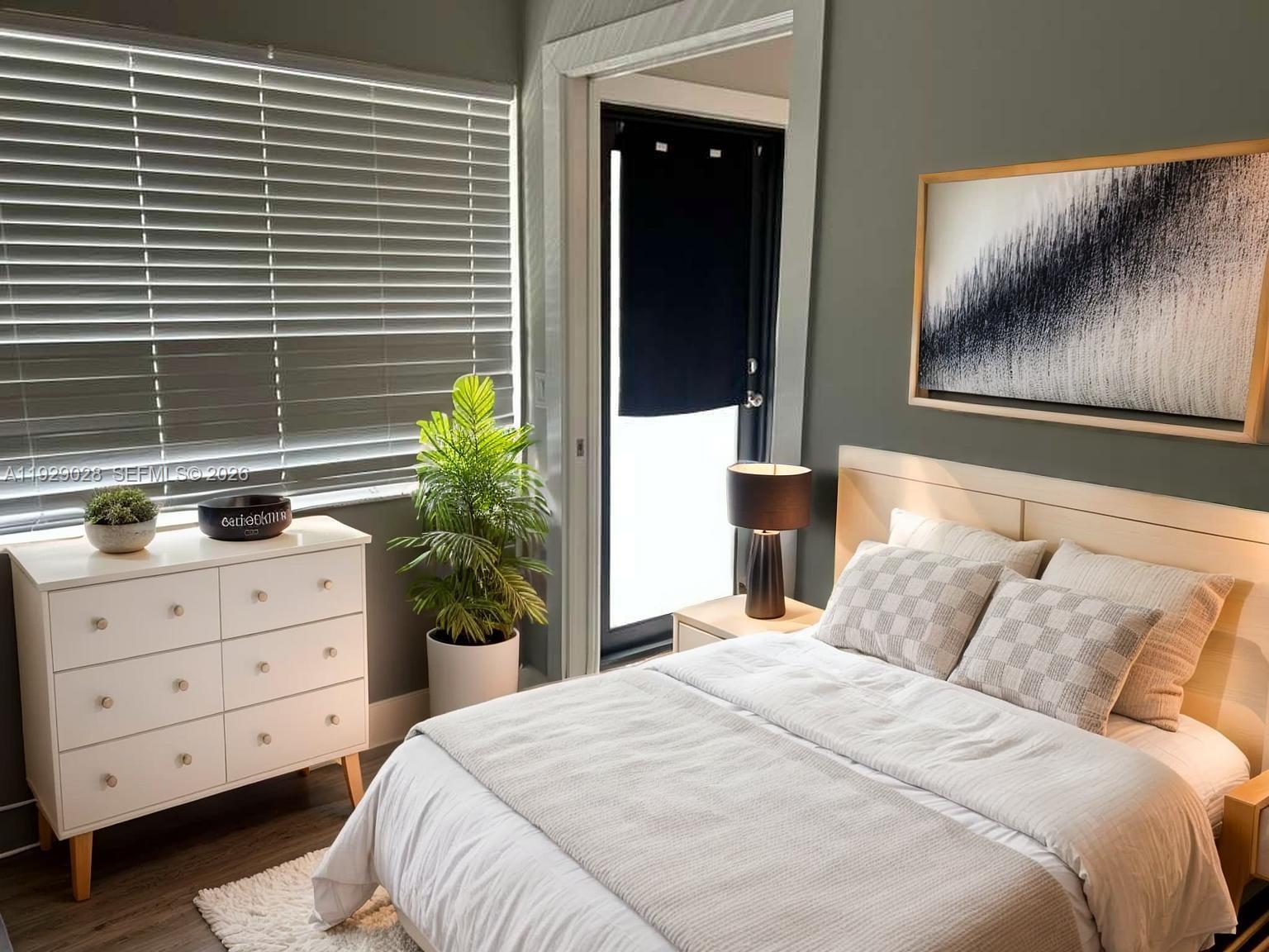 335 Southwest 20th Street, Unit 7 Fort Lauderdale, FL 33315 - Photo 12 of 17 a bedroom with a bed and a window