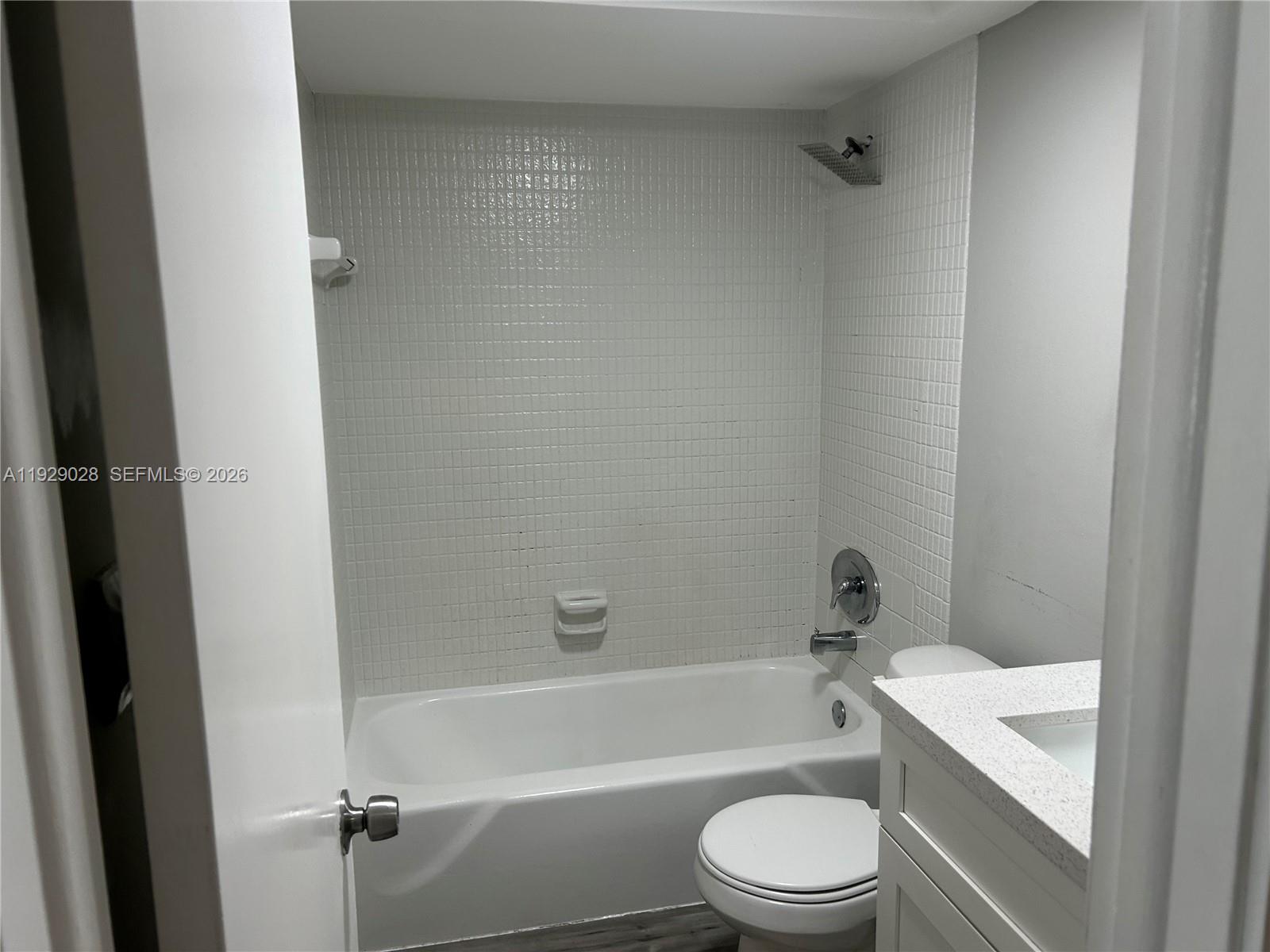 335 Southwest 20th Street, Unit 7 Fort Lauderdale, FL 33315 - Photo 16 of 17 a bathroom with a toilet a sink and bathtub