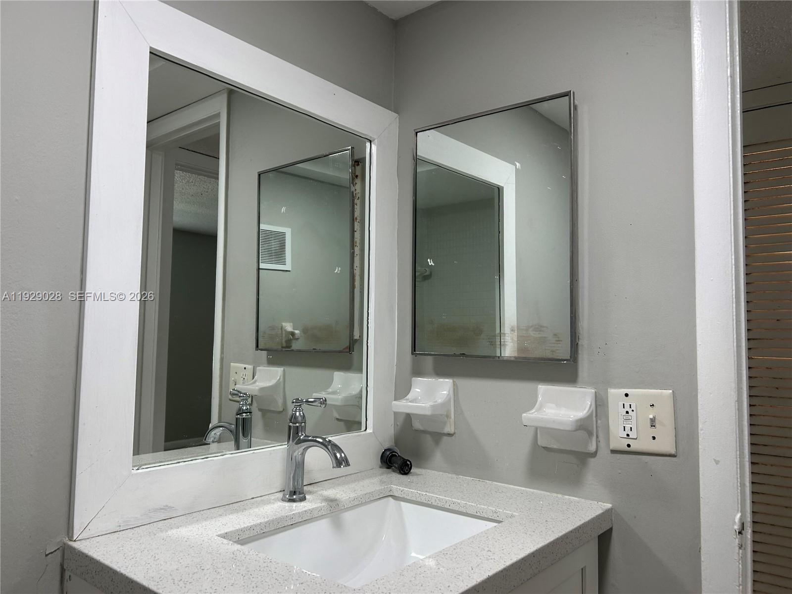 335 Southwest 20th Street, Unit 7 Fort Lauderdale, FL 33315 - Photo 17 of 17 a bathroom with a sink and a mirror