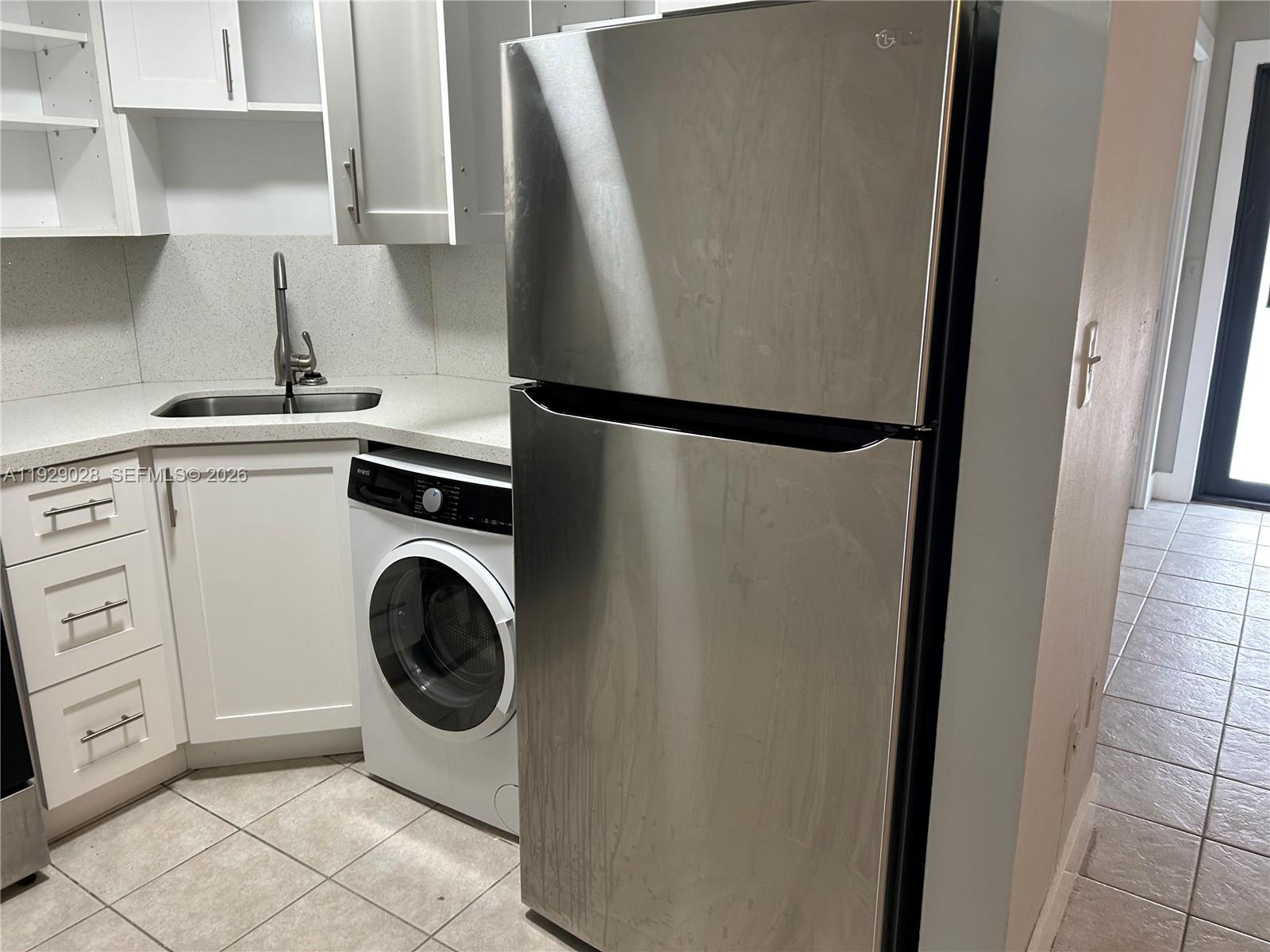 335 Southwest 20th Street, Unit 7 Fort Lauderdale, FL 33315 - Photo 2 of 17 a utility room with dryer and washer