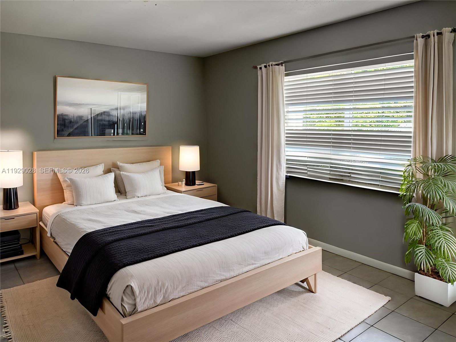 335 Southwest 20th Street, Unit 7 Fort Lauderdale, FL 33315 - Photo 7 of 17 a bedroom with a bed and a painting on the wall