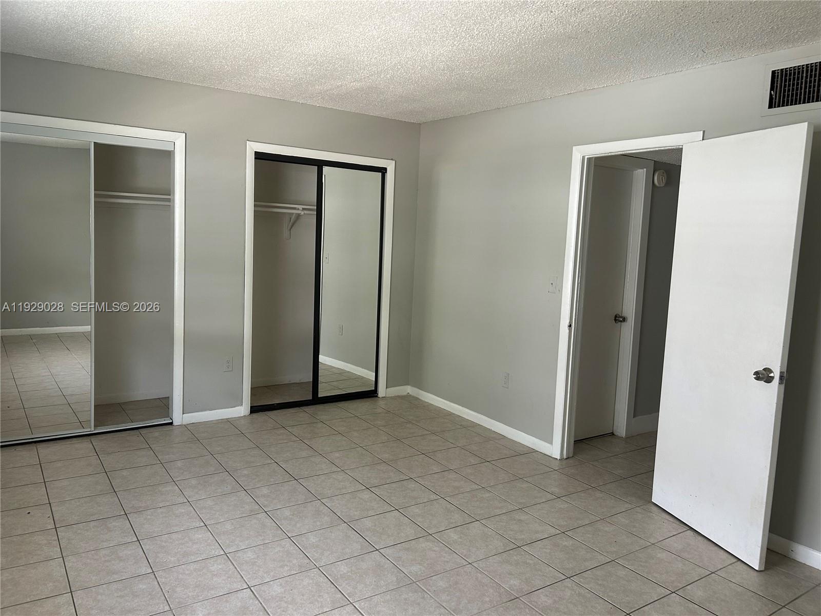335 Southwest 20th Street, Unit 7 Fort Lauderdale, FL 33315 - Photo 10 of 17 a view of an empty room with wooden door