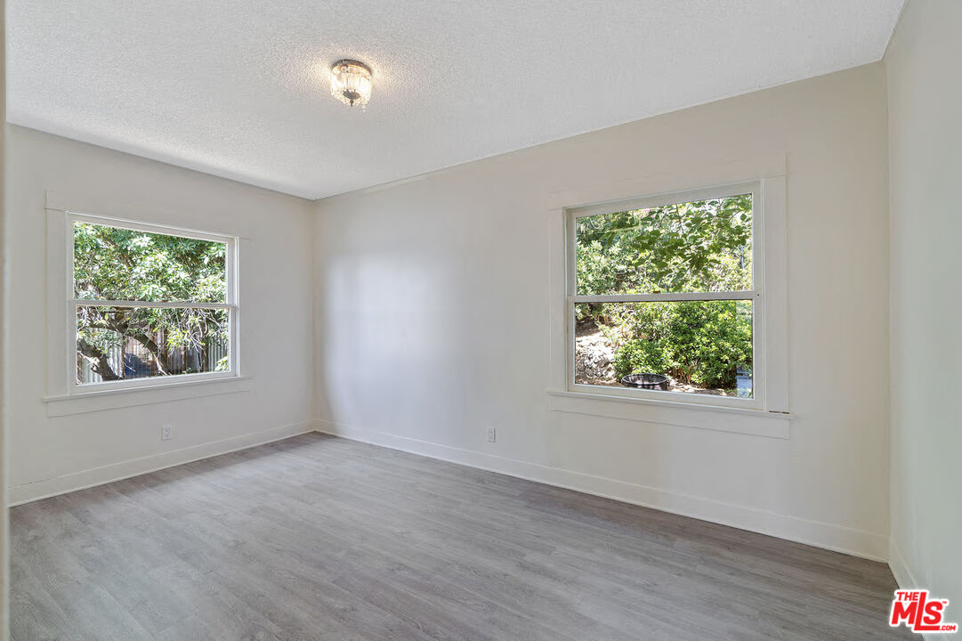 2117 Vestal Avenue Los Angeles, CA 90026 - Photo 17 of 26 an empty room with wooden floor and windows