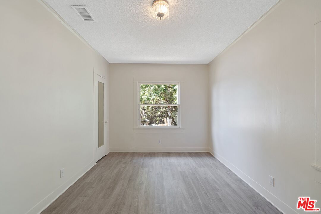 2117 Vestal Avenue Los Angeles, CA 90026 - Photo 18 of 26 an empty room with wooden floor and windows