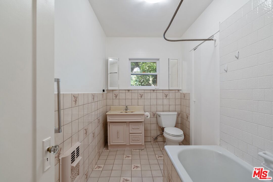 2117 Vestal Avenue Los Angeles, CA 90026 - Photo 19 of 26 a bathroom with a bathtub a toilet a sink and a shower