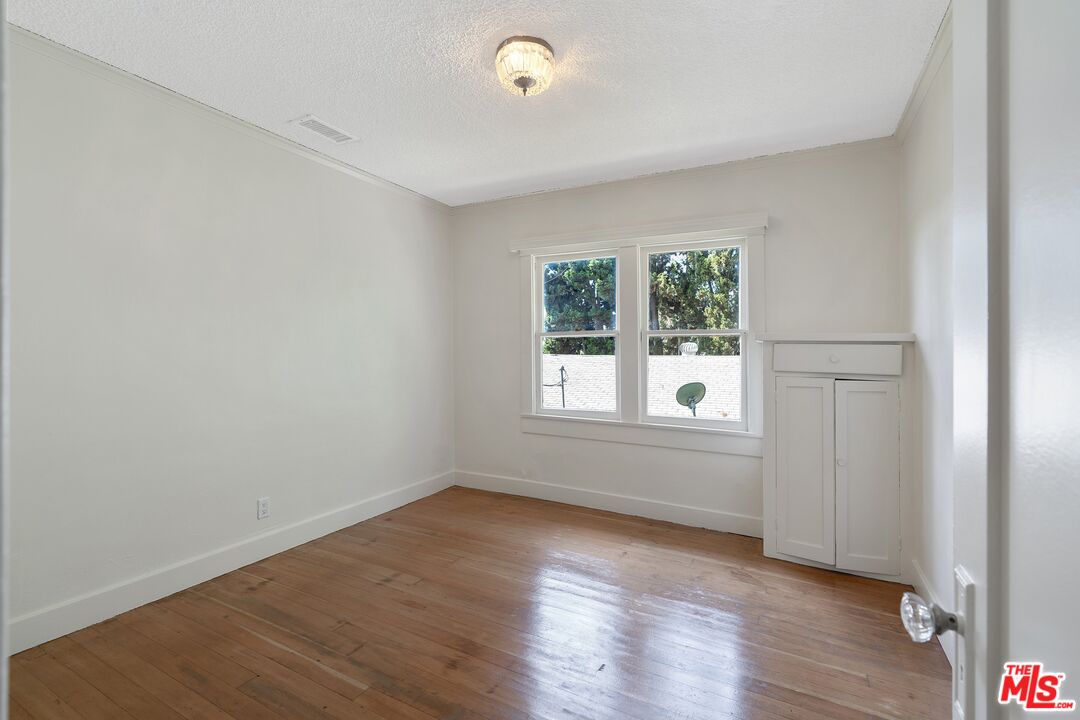 2117 Vestal Avenue Los Angeles, CA 90026 - Photo 21 of 26 an empty room with wooden floor and windows