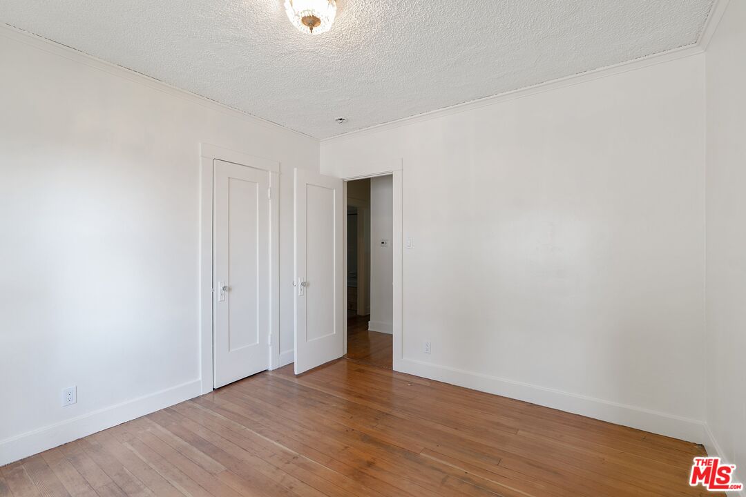 2117 Vestal Avenue Los Angeles, CA 90026 - Photo 22 of 26 a view of an empty room with wooden floor