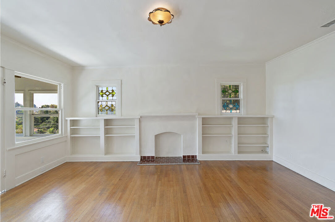 2117 Vestal Avenue Los Angeles, CA 90026 - Photo 7 of 26 a view of empty room with wooden floor and fan