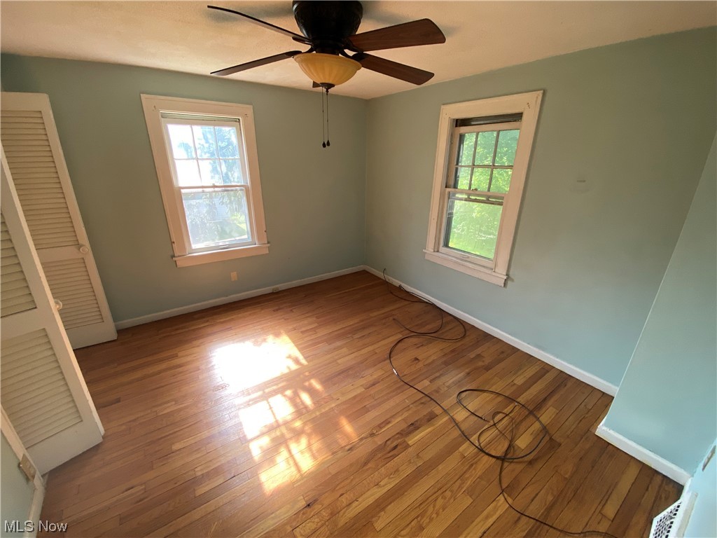 3630 Bainbridge Road Cleveland Heights, OH 44118 - Photo 13 of 21 Unfurnished room with hardwood / wood-style flooring and ceiling fan