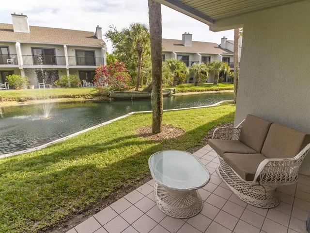 a swimming pool with outdoor seating and yard