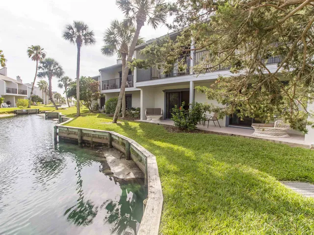 a view of a house with swimming pool and sitting area