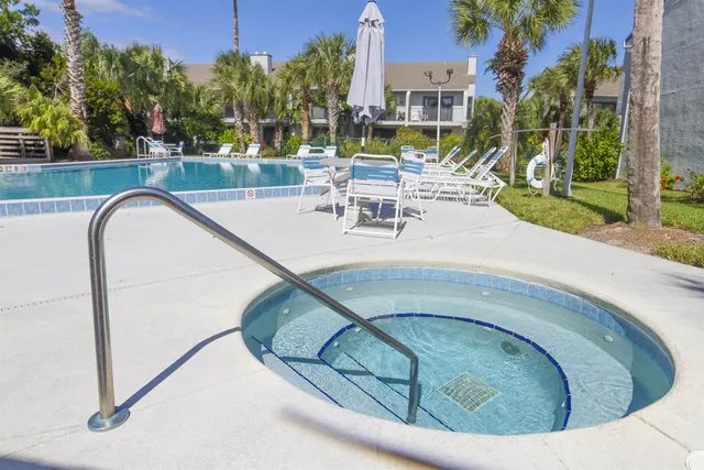 a view of swimming pool with outdoor seating and plants