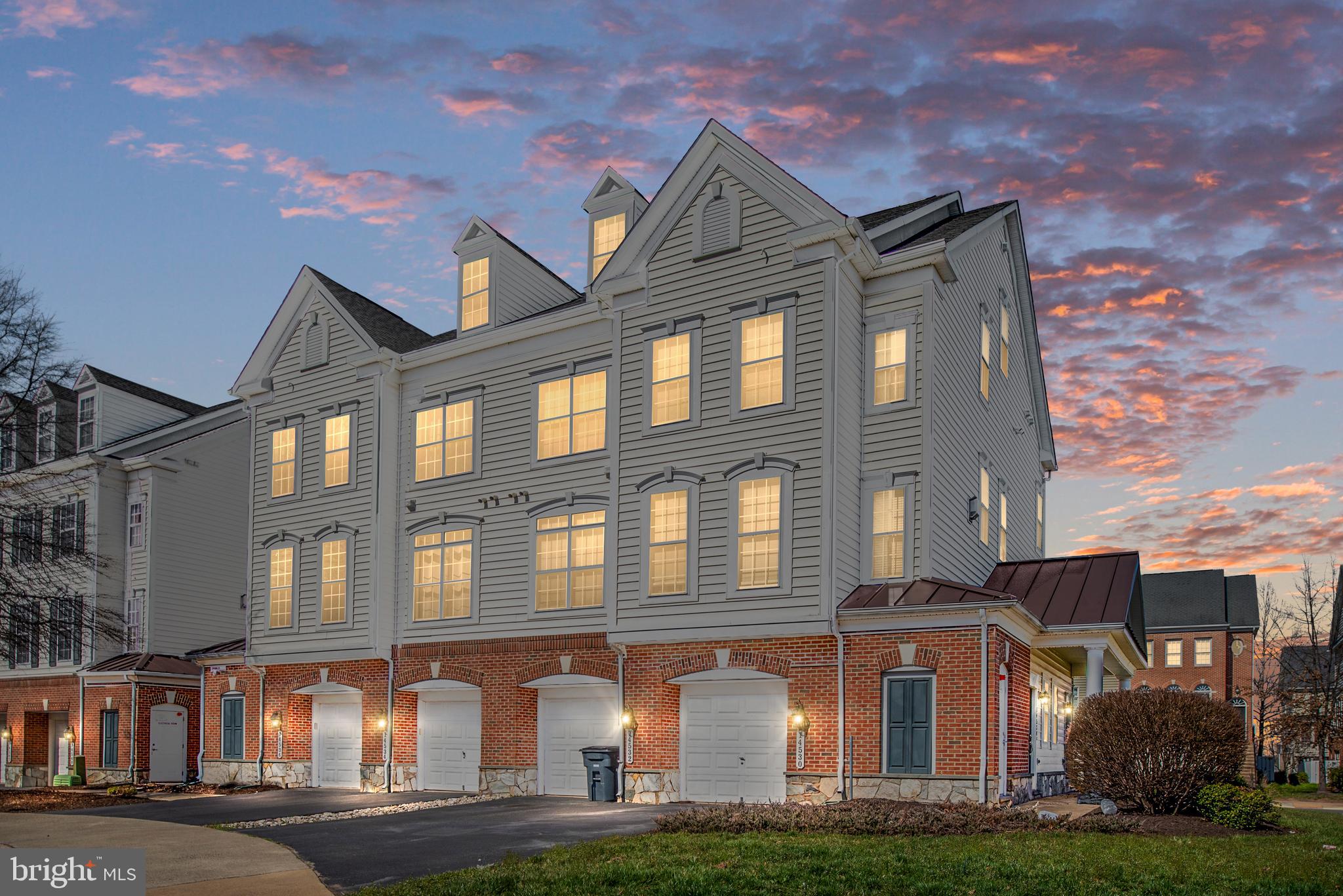 a front view of a residential apartment building with a yard