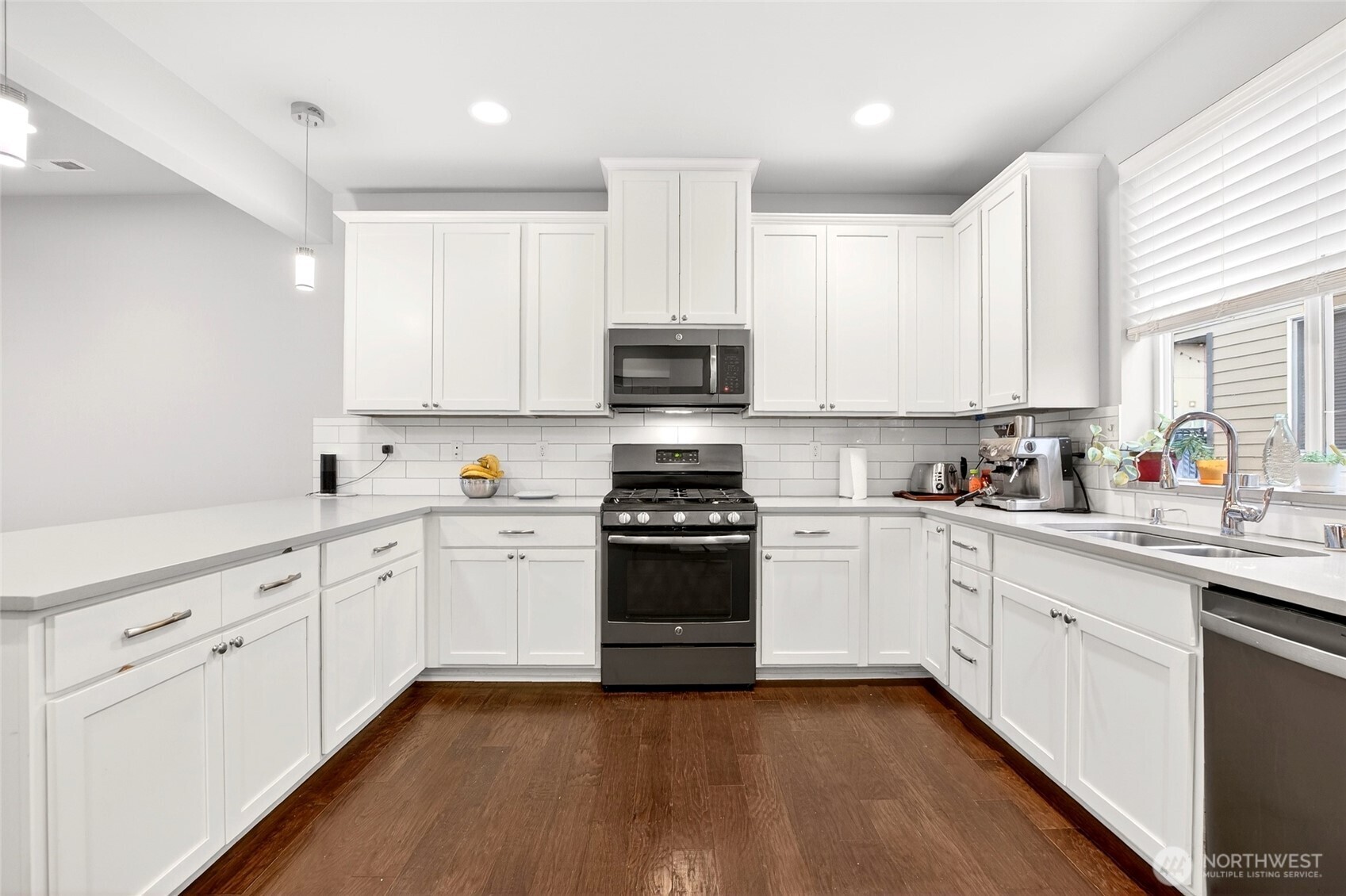 22925 79th Place West, Unit B Edmonds, WA 98026 - Photo 2 of 39 a kitchen with granite countertop white cabinets and stainless steel appliances