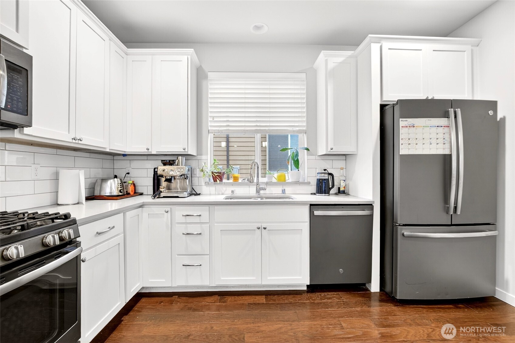 22925 79th Place West, Unit B Edmonds, WA 98026 - Photo 4 of 39 a kitchen with granite countertop white cabinets and stainless steel appliances