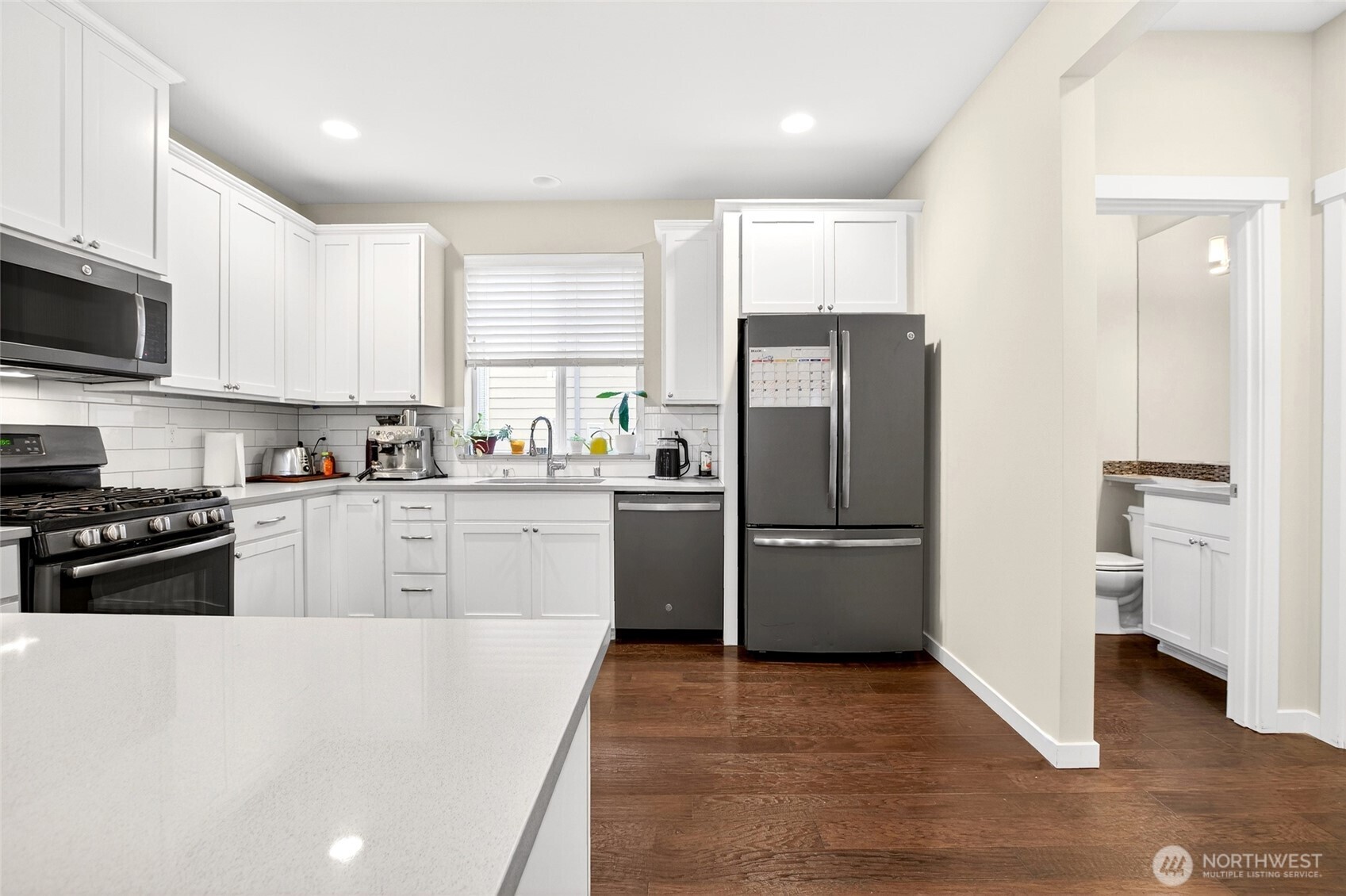22925 79th Place West, Unit B Edmonds, WA 98026 - Photo 6 of 39 a kitchen with a refrigerator a stove top oven a sink and dishwasher