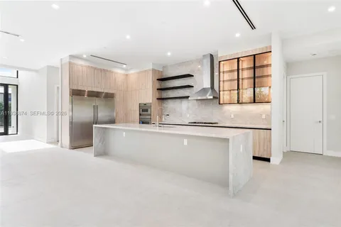 a kitchen with stainless steel appliances granite countertop a refrigerator and a sink