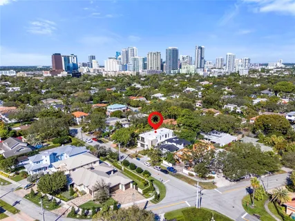 an aerial view of a house with a yard and garden