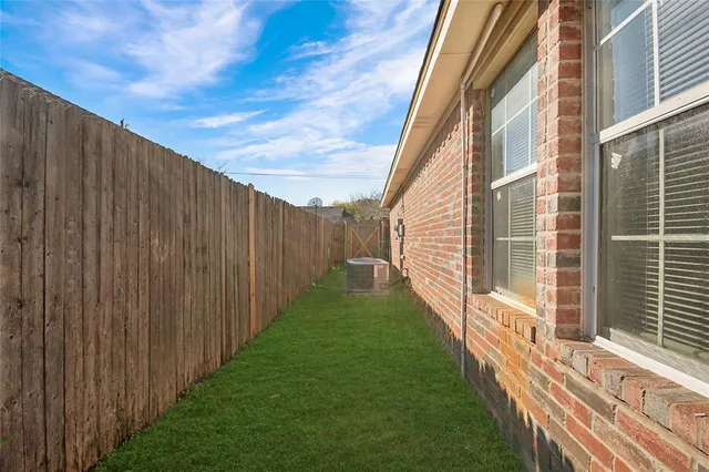 a view of a backyard with wooden fence