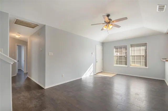 a view of a livingroom with a ceiling fan and window