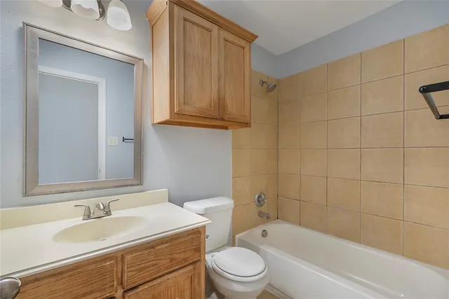 a bathroom with a sink a toilet and bathtub