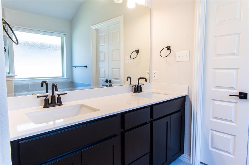 2604 Freeman Street Anna, TX 75409 - Photo 8 of 18 a bathroom with a sink and a mirror