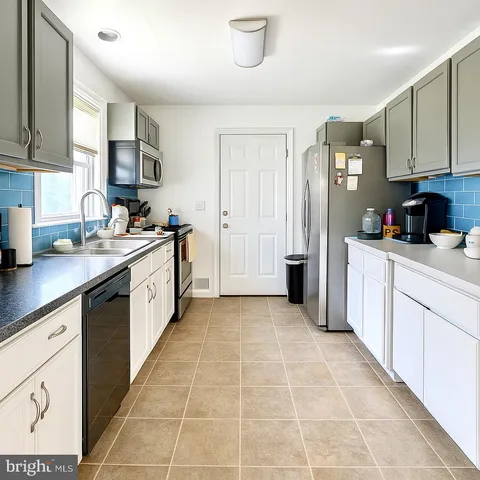 a kitchen with a sink stove and cabinets