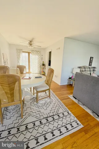 a living room with furniture rug and a table
