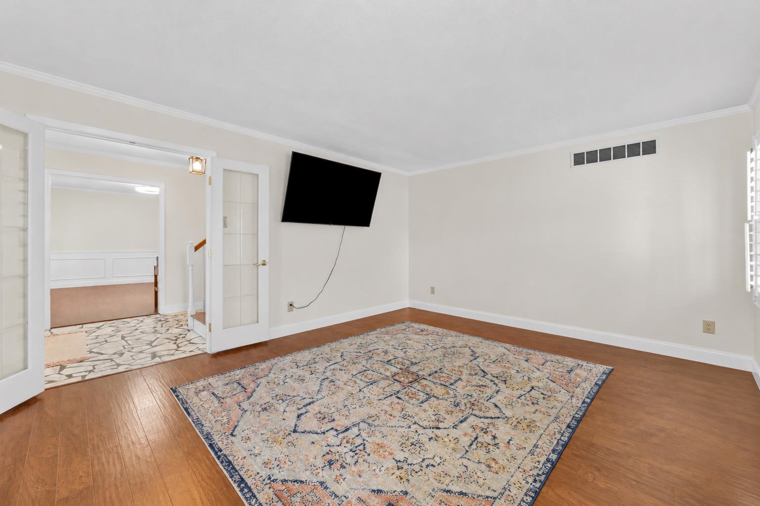 2218 Riverdale Road Germantown, TN 38138 - Photo 11 of 40 Large living room featuring beautiful flooring, neutral colors, and ample wall space for furniture placement. A versatile gathering area perfect for relaxing or hosting guests.