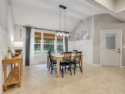 a dining room with furniture and window