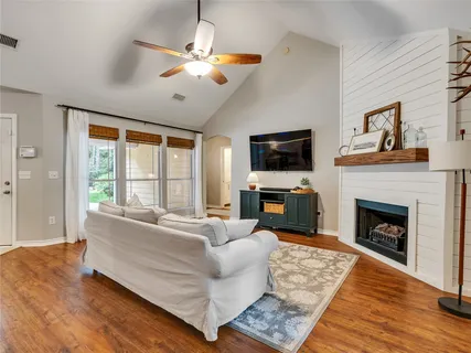 a living room with furniture fireplace and flat screen tv