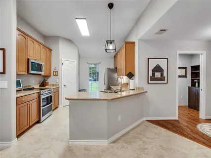a kitchen with stainless steel appliances granite countertop a stove and a sink